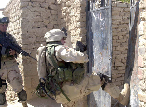 1st Infantry Soldier Kicks Open A Gate In Samarra, Iraq