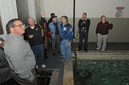 Councilman Dominick Calsolaro (front), who opposes closing the bath, tours the facility Monday with several of his colleagues. City Historian Anthony Opalka (Yankees jacket) also toured the 105-year-old facility for the first time.