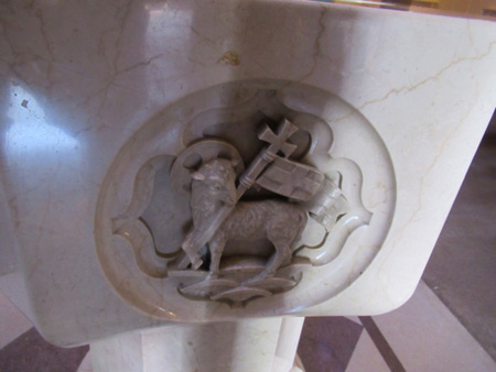 Lamb Of God Triumphant On The Font, Facing The Entrance Of The Church